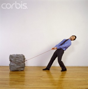 Man-pulling-heavy-rock-296x300.jpg